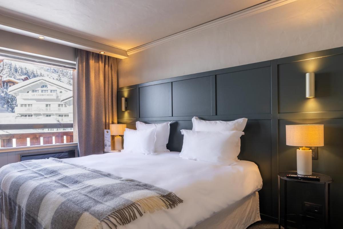 Un ou plusieurs lits dans un hébergement de l'établissement Grand Hôtel Courchevel 1850