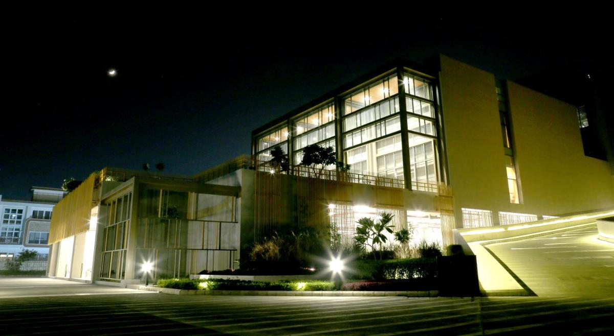 a large building at night with its lights on at The Centrum in Lucknow