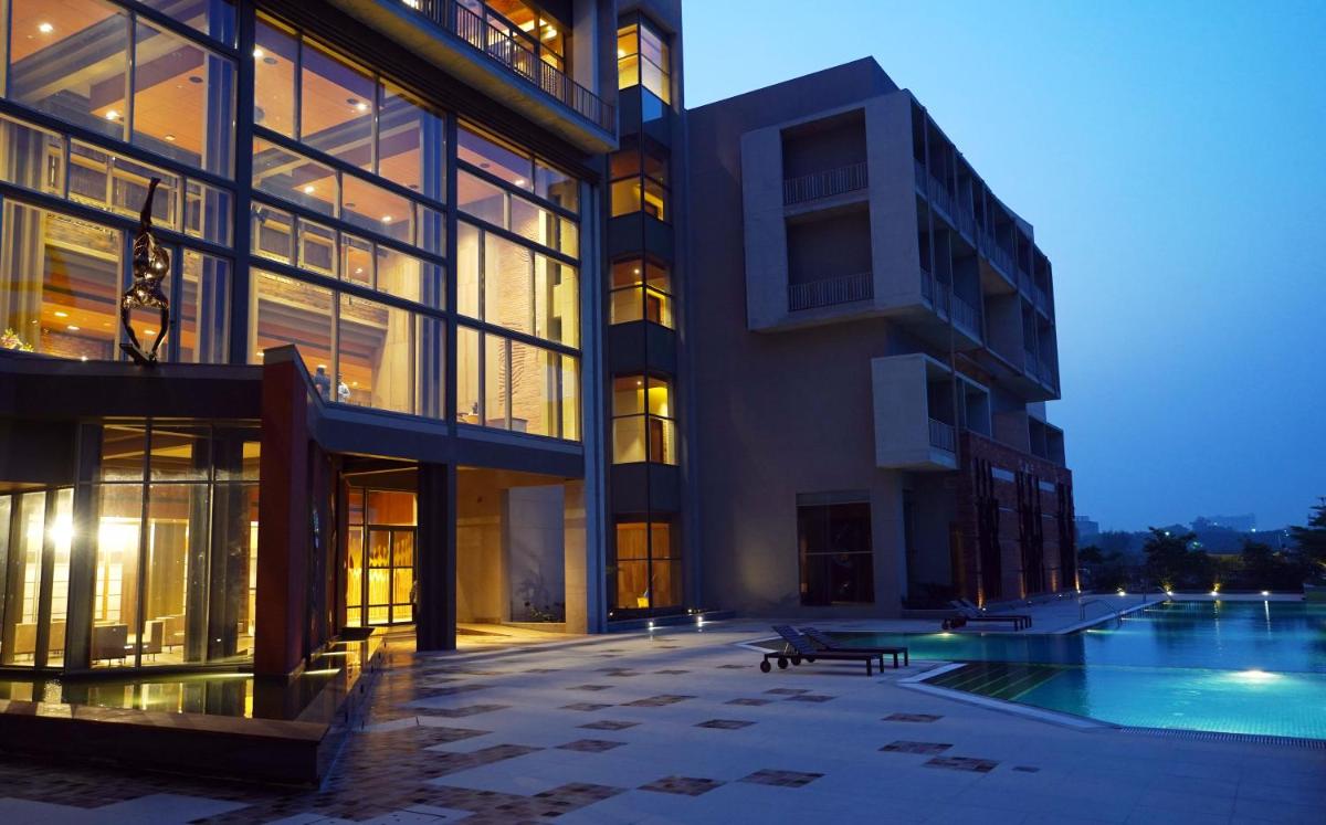 a large building with a pool in front of it at The Centrum in Lucknow