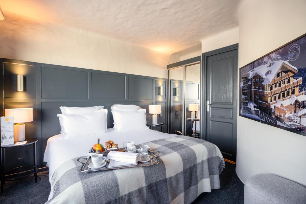 Un ou plusieurs lits dans un hébergement de l'établissement Grand Hôtel Courchevel 1850
