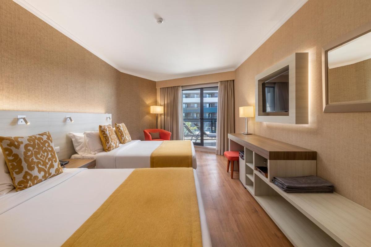 Uma cama ou camas num quarto em Enotel Lido - All Inclusive