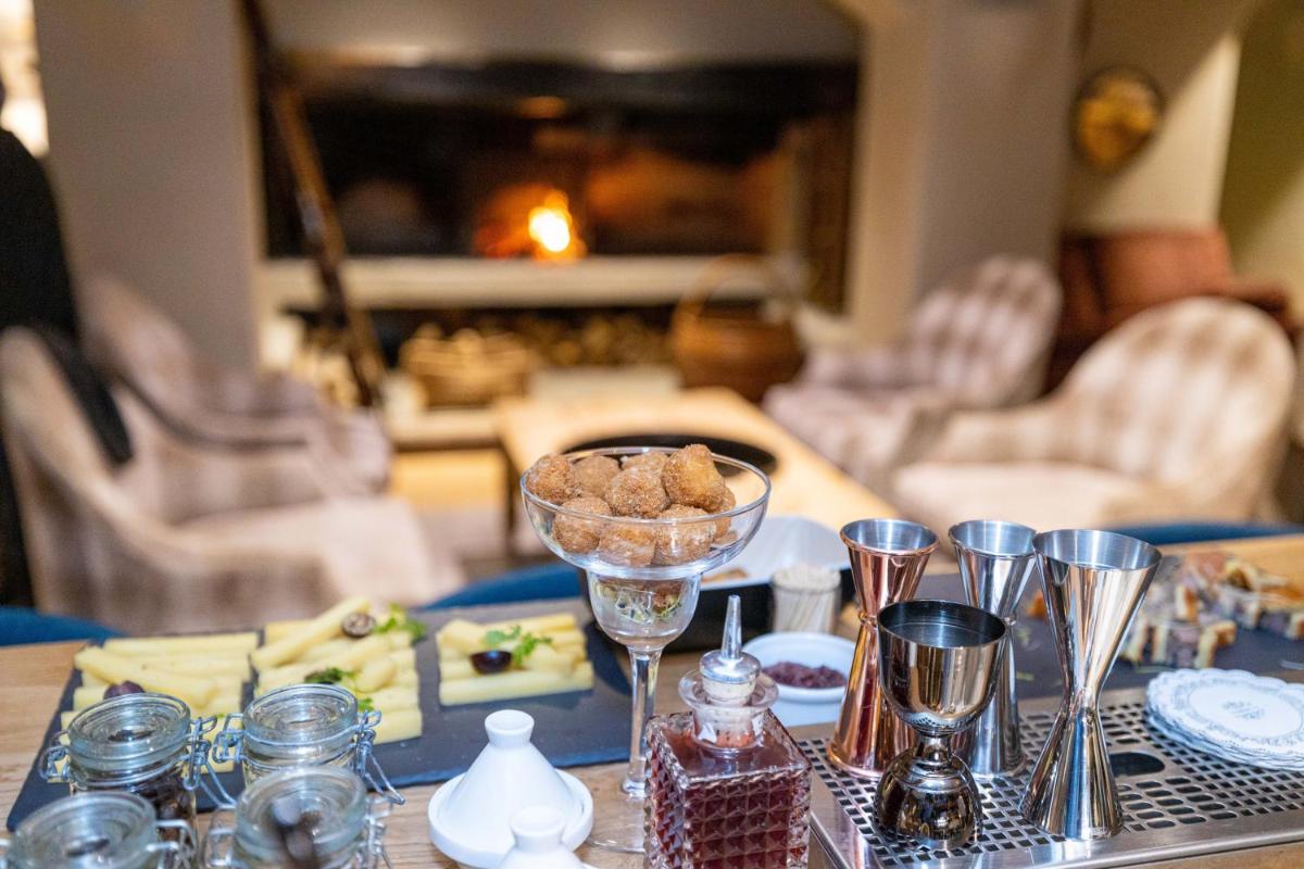 une table avec une assiette de nourriture et des verres à vin dans l'établissement Grand Hôtel Courchevel 1850, à Courchevel