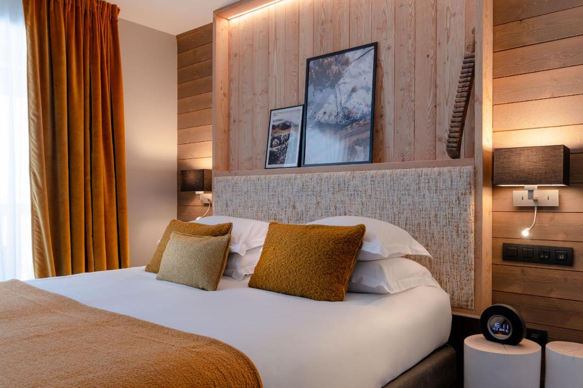 Un ou plusieurs lits dans un hébergement de l'établissement ILY Hotels & Spa La Rosiere