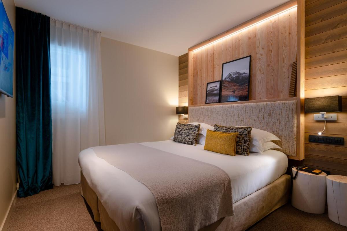 Un ou plusieurs lits dans un hébergement de l'établissement ILY Hotels & Spa La Rosiere