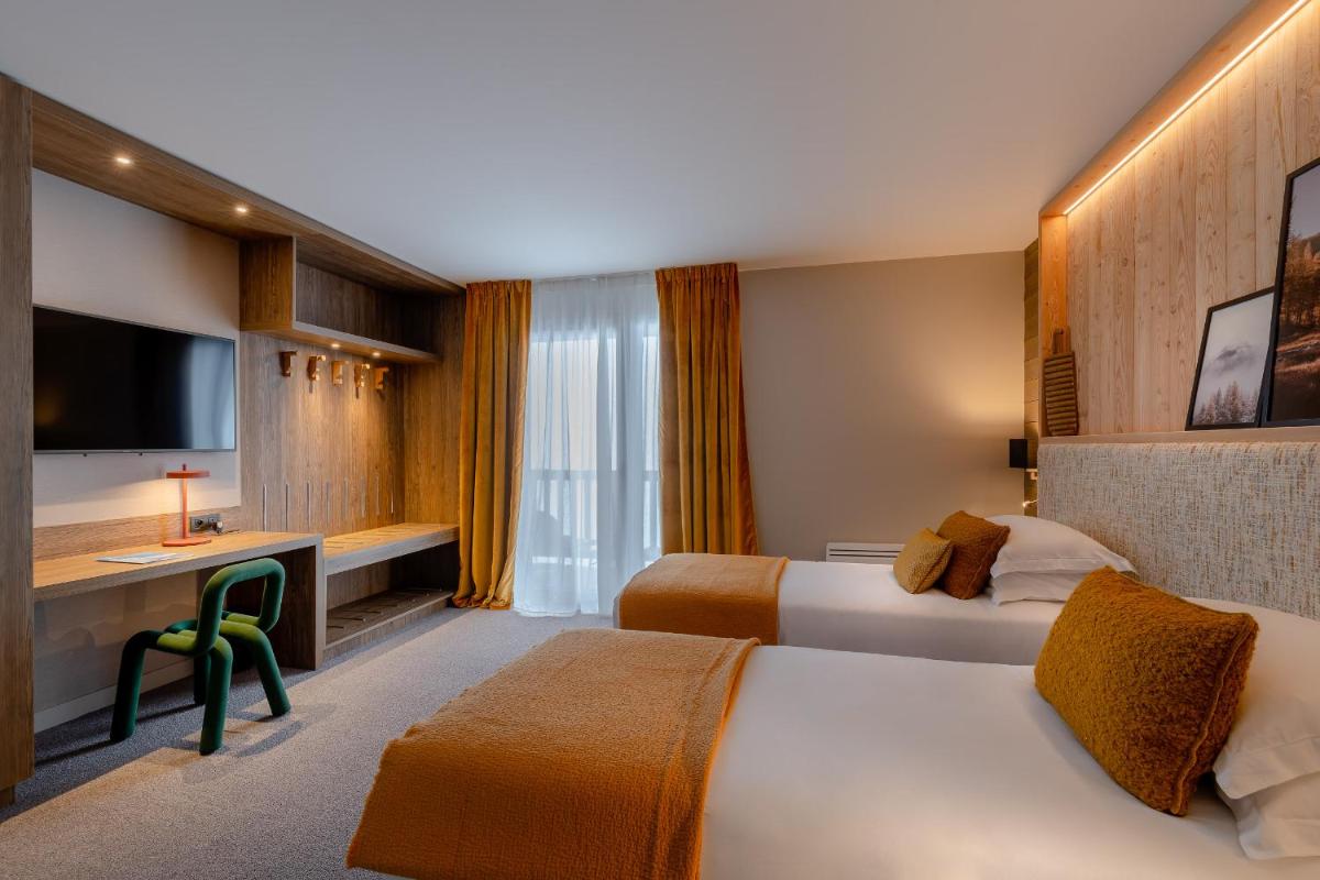 Un ou plusieurs lits dans un hébergement de l'établissement ILY Hotels & Spa La Rosiere