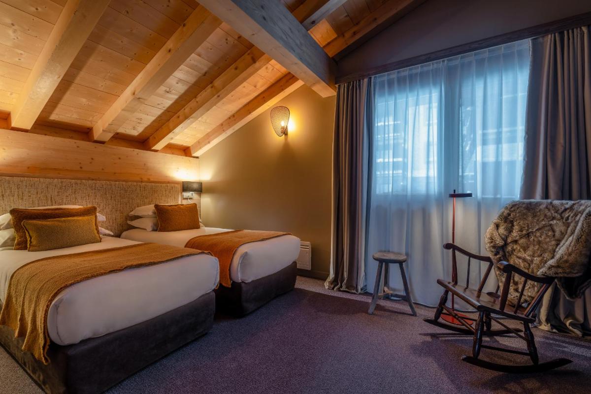 Un ou plusieurs lits dans un hébergement de l'établissement ILY Hotels & Spa La Rosiere