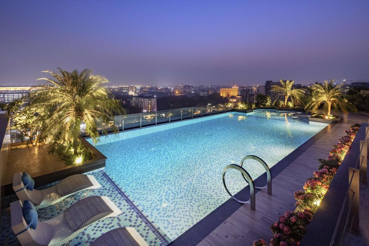 a large swimming pool on top of a building at Radisson Blu Mumbai International Airport in Mumbai a large swimming pool on top of a building at Radisson Blu Mumbai International Airport in Mumbai