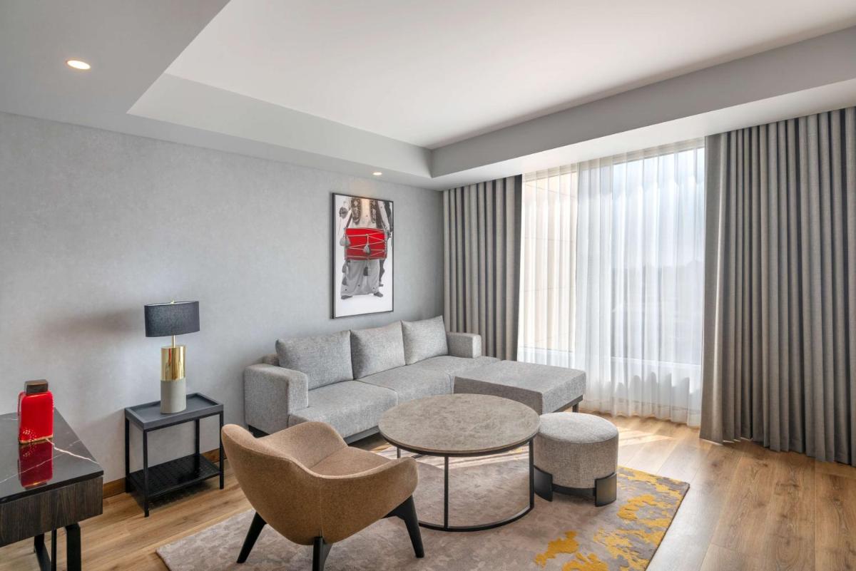 a living room with a couch and a table at Radisson RED Chandigarh Mohali in Chandīgarh