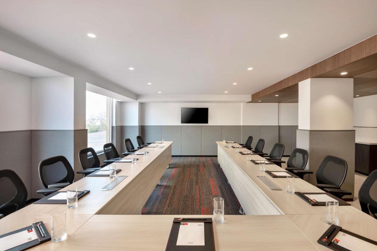 a large conference room with long tables and chairs at Radisson RED Chandigarh Mohali in Chandīgarh