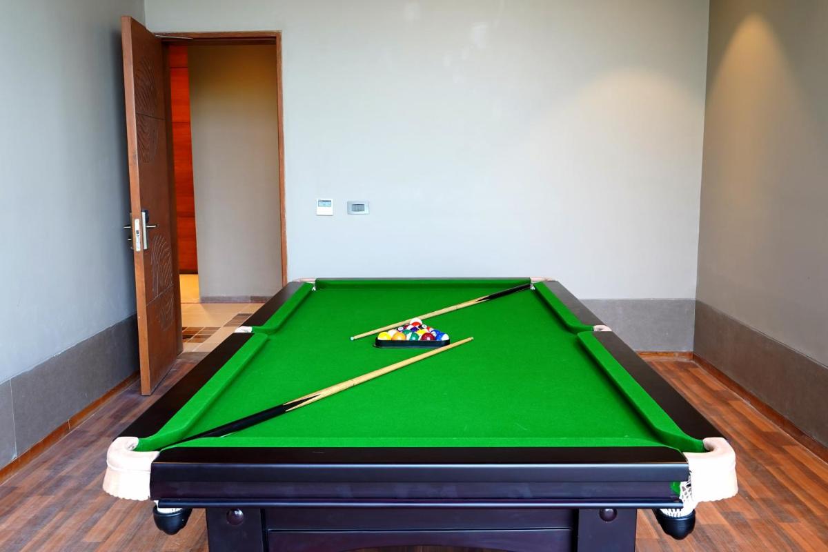 a pool table with two cuesticks on top of it at The Centrum in Lucknow