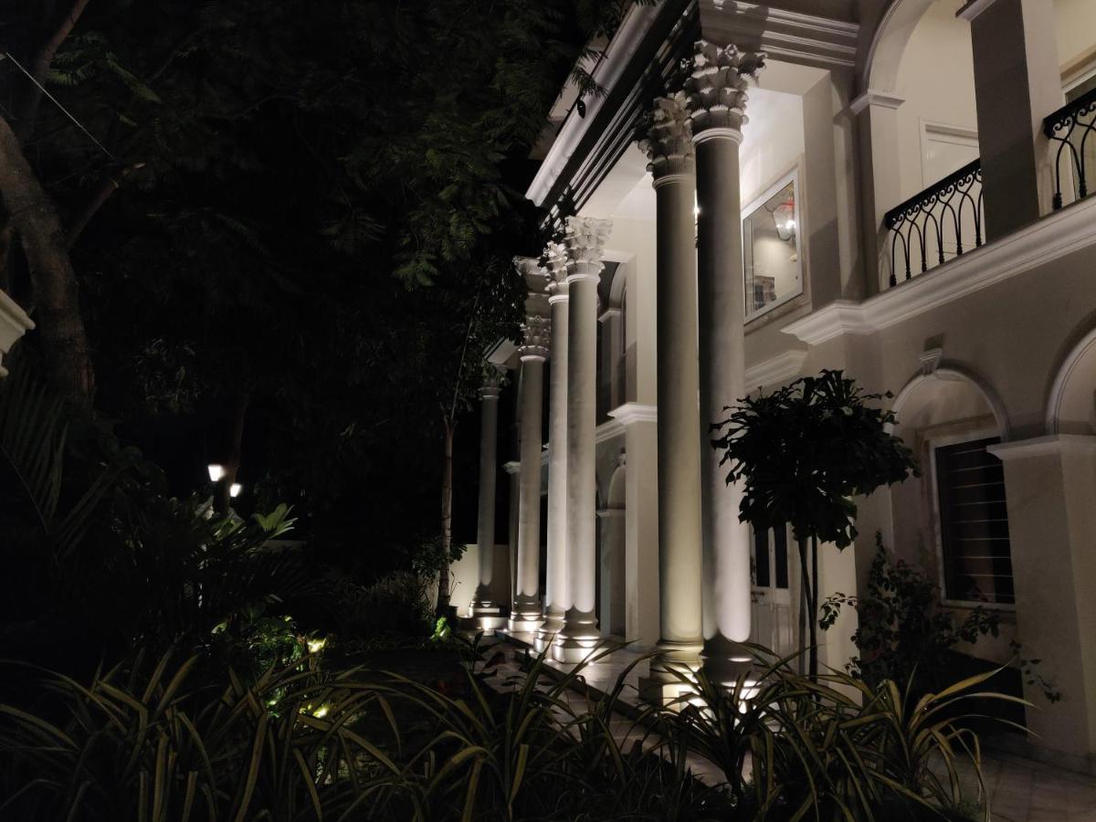 a lit up building with columns at night at Dileep Kothi - A Royal Boutique Luxury Suites in Jaipur in Jaipur