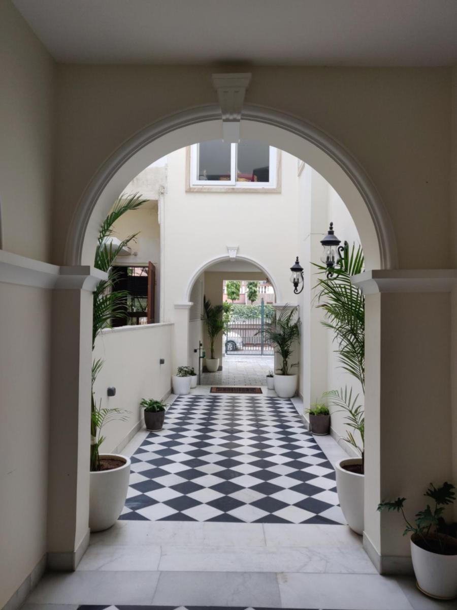 an archway in a building with a black and white checkered floor at Dileep Kothi - A Royal Boutique Luxury Suites in Jaipur in Jaipur