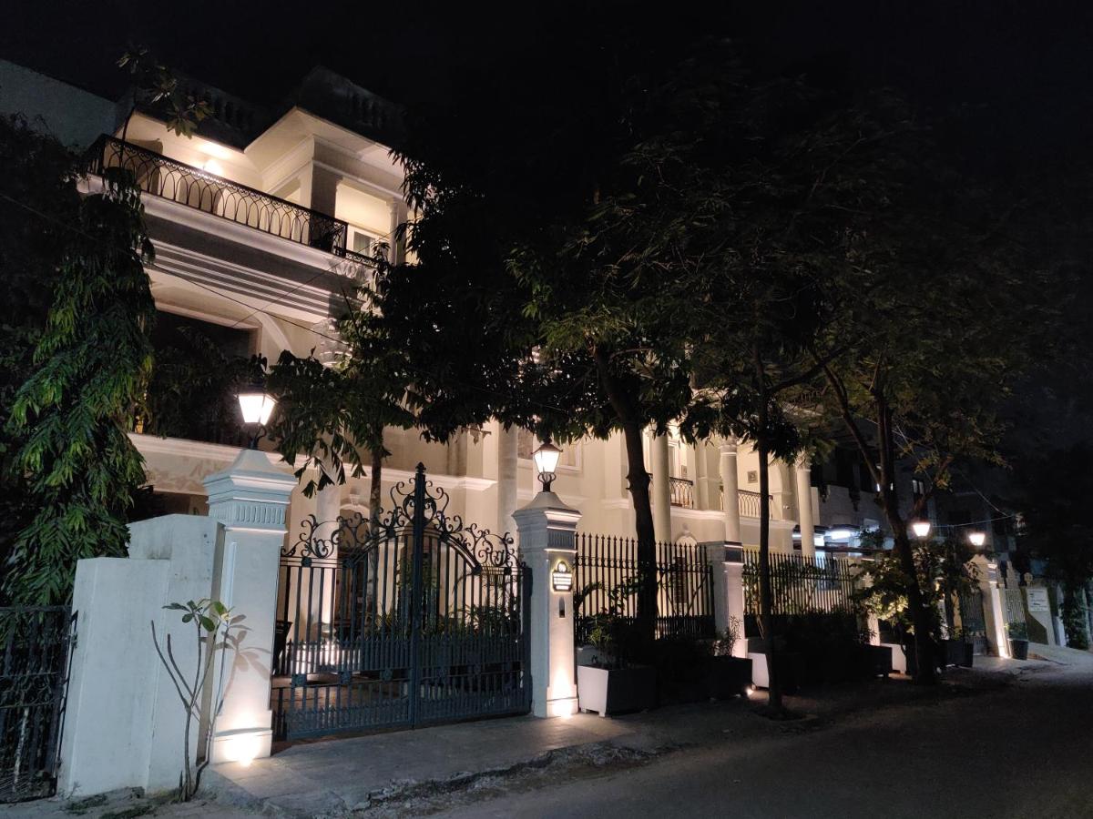 a white house with a gate at night at Dileep Kothi - A Royal Boutique Luxury Suites in Jaipur in Jaipur
