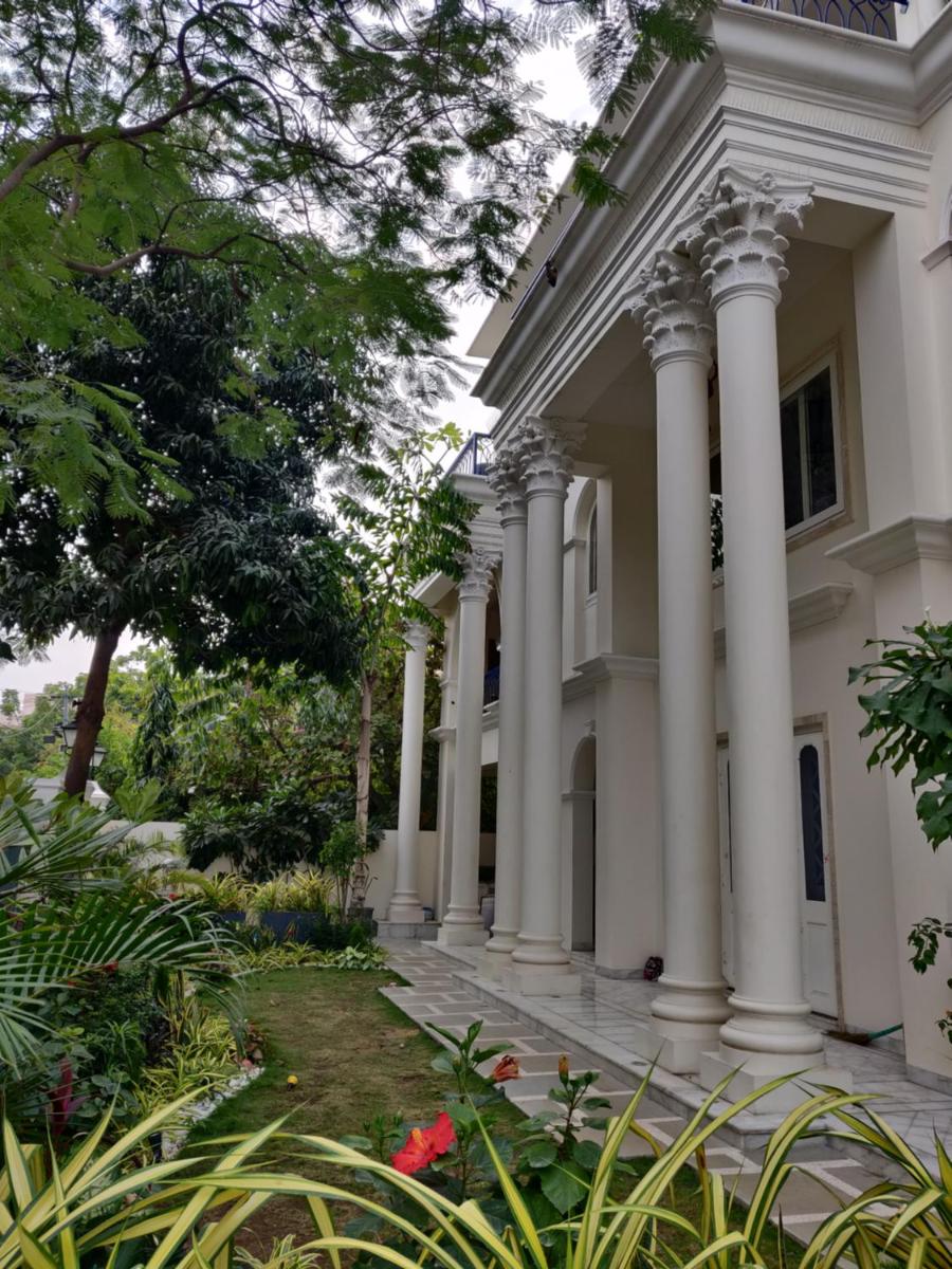 a large white house with columns at Dileep Kothi - A Royal Boutique Luxury Suites in Jaipur in Jaipur