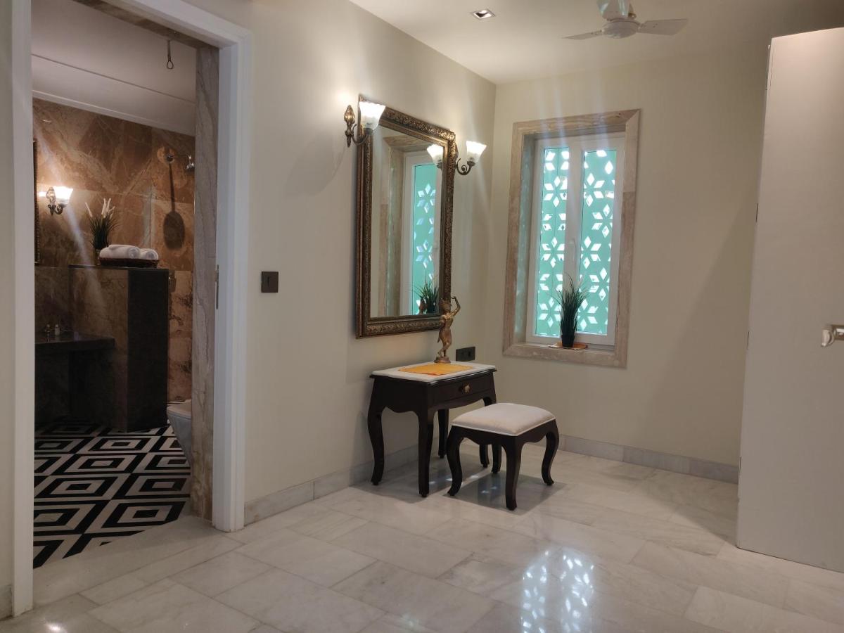 a bathroom with a table and a mirror and a stool at Dileep Kothi - A Royal Boutique Luxury Suites in Jaipur in Jaipur