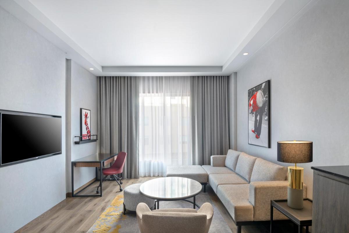 a living room with a couch and a table at Radisson RED Chandigarh Mohali in Chandīgarh