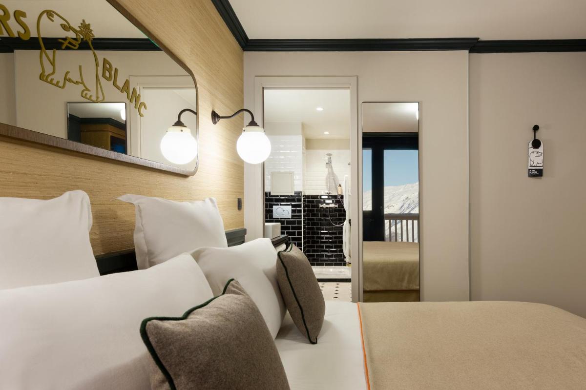Un ou plusieurs lits dans un hébergement de l'établissement Ours Blanc Hotel & Spa