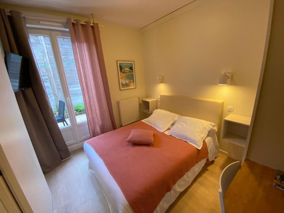 Un ou plusieurs lits dans un hébergement de l'établissement Hôtel de charme & SPA Le Grand Large