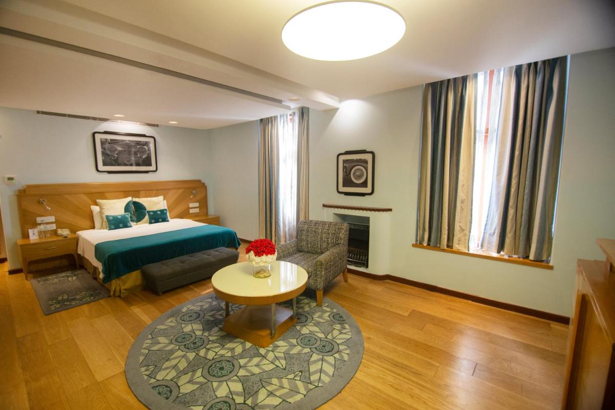 a hotel room with a bed and a table at Ambassador, New Delhi - IHCL SeleQtions in New Delhi +126 photos a hotel room with a bed and a table at Ambassador, New Delhi - IHCL SeleQtions in New Delhi +126 photos