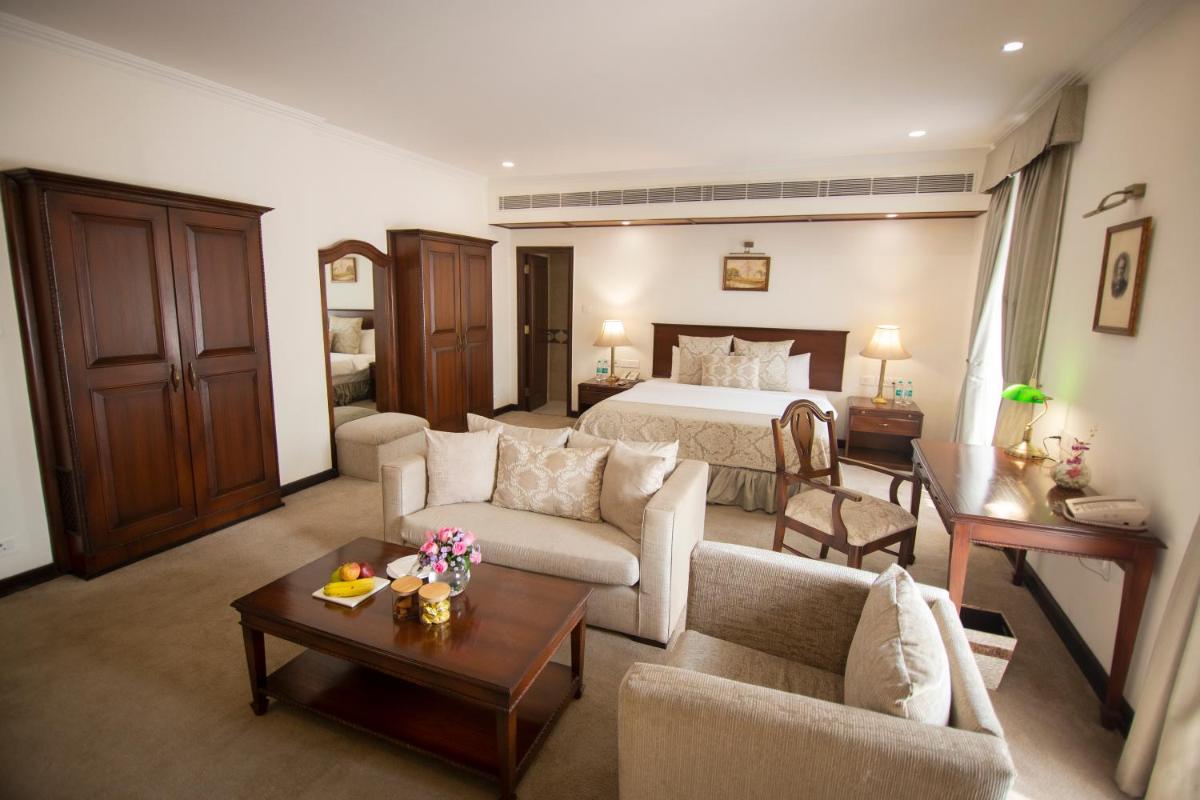 a large living room with a bed and a couch at Ambassador, New Delhi - IHCL SeleQtions in New Delhi a large living room with a bed and a couch at Ambassador, New Delhi - IHCL SeleQtions in New Delhi
