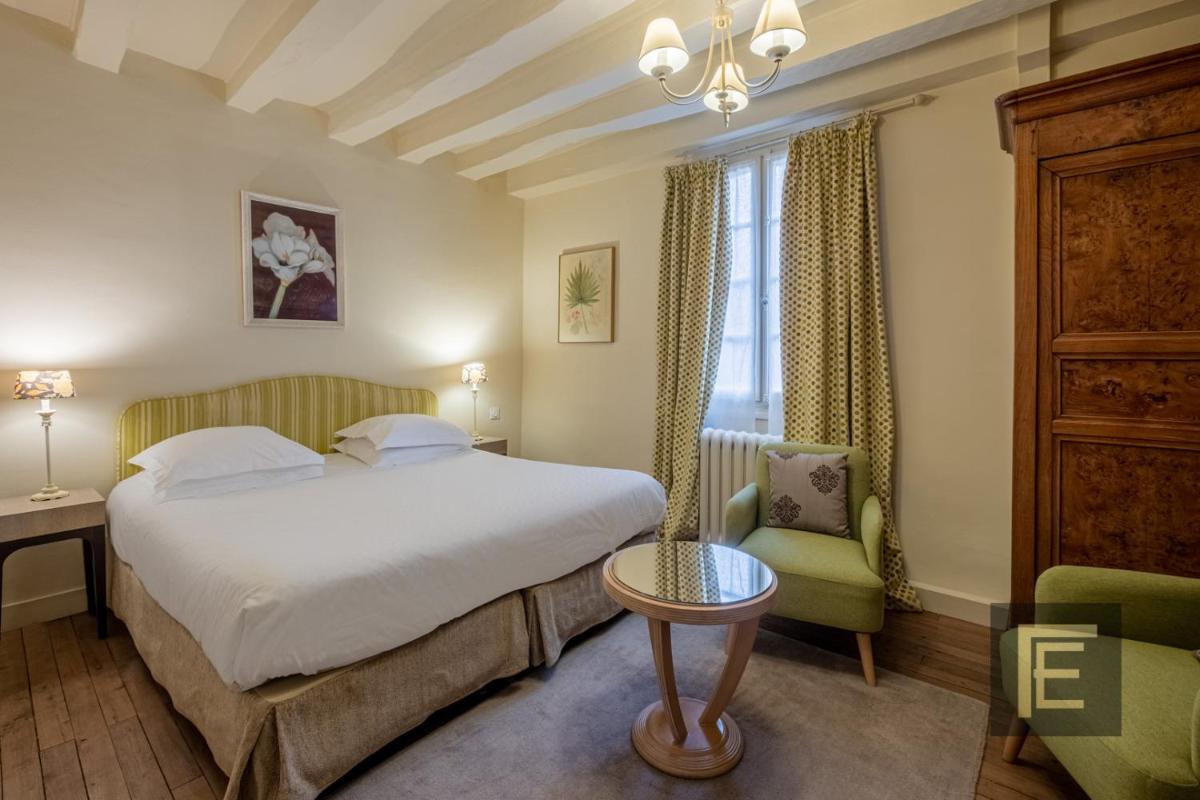 Un ou plusieurs lits dans un hébergement de l'établissement Auberge du Bon Laboureur Chenonceaux
