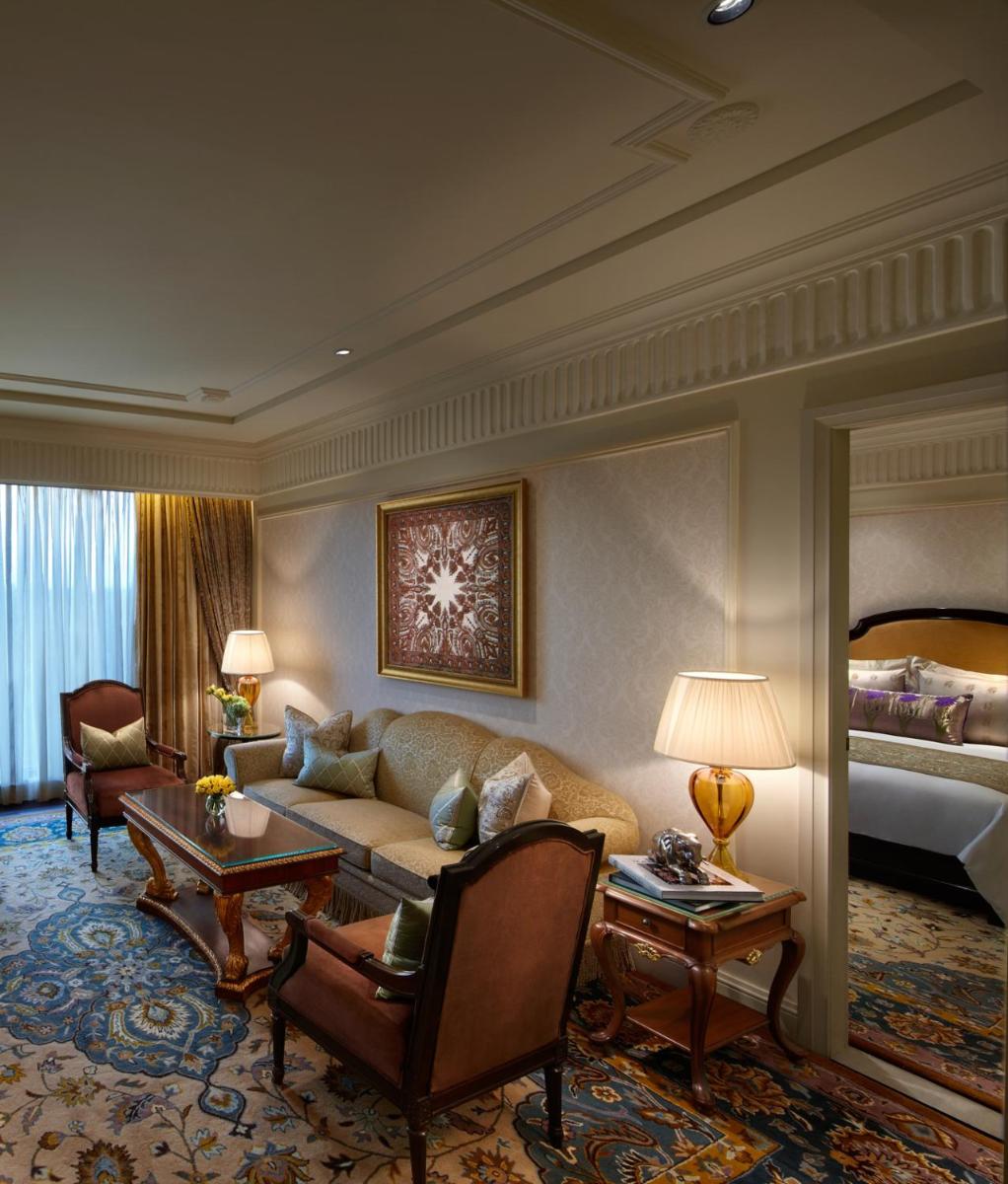 a living room with a couch and a bed at The Leela Palace New Delhi in New Delhi a living room with a couch and a bed at The Leela Palace New Delhi in New Delhi