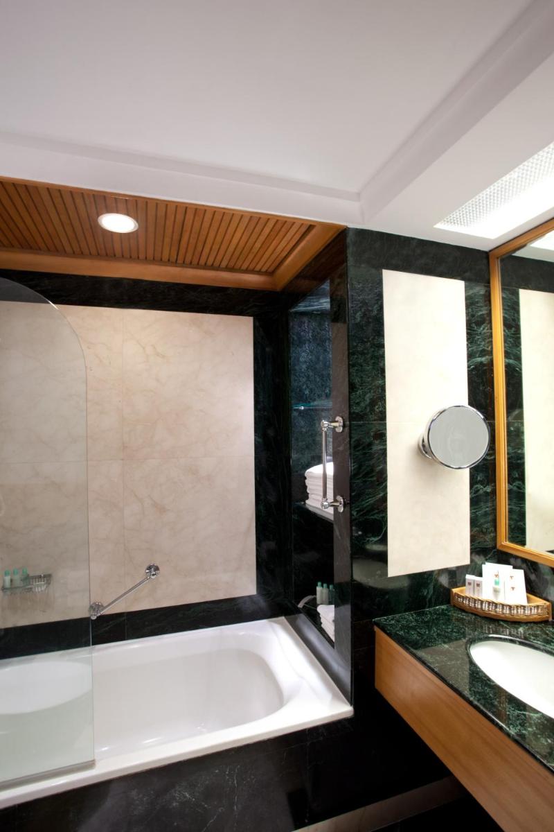 a bathroom with a bath tub and a sink at Trident Chennai in Chennai