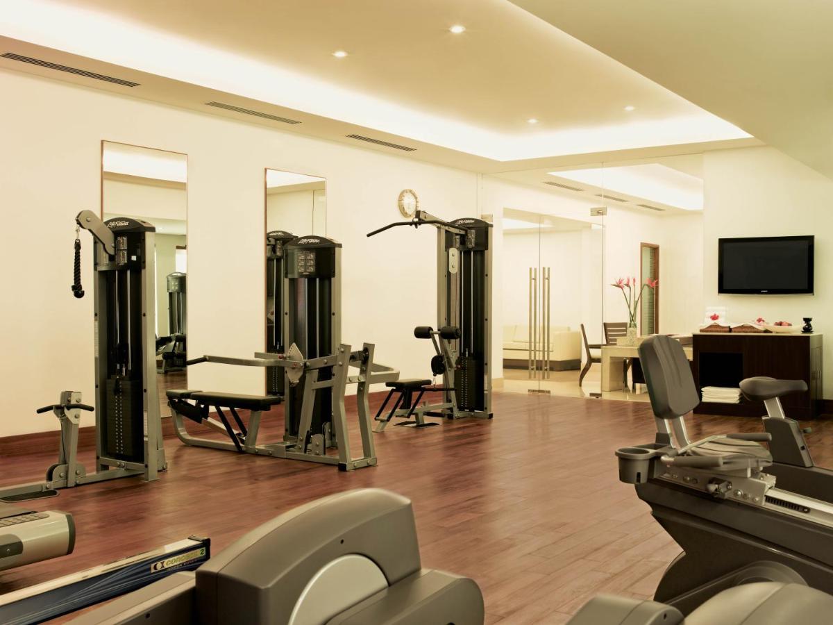 a gym with several exercise equipment in a room at Trident Chennai in Chennai