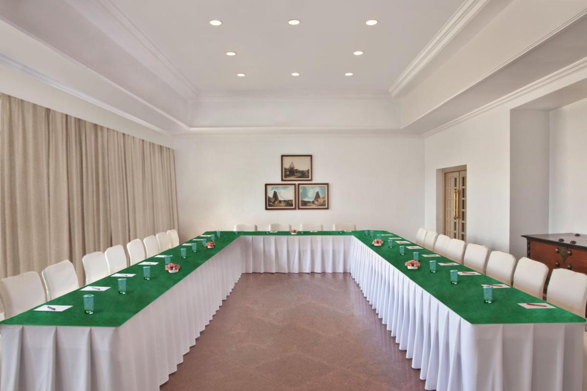 a conference room with a long table with white chairs at Trident Chennai in Chennai +66 photos