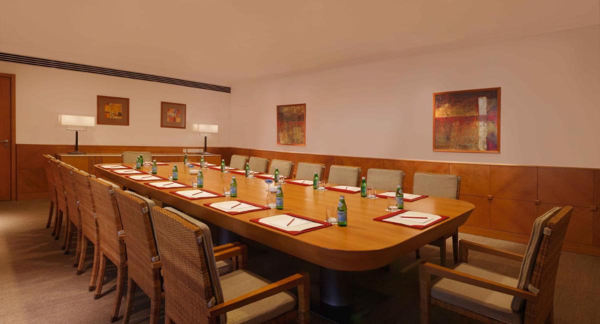 a conference room with a long table and chairs at Trident Chennai in Chennai