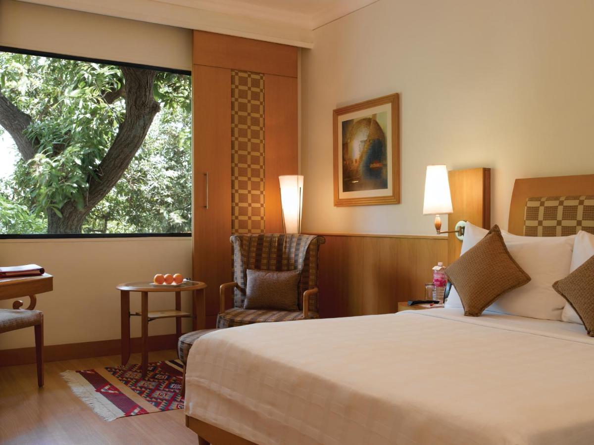 a hotel room with a bed and a window at Trident Chennai in Chennai