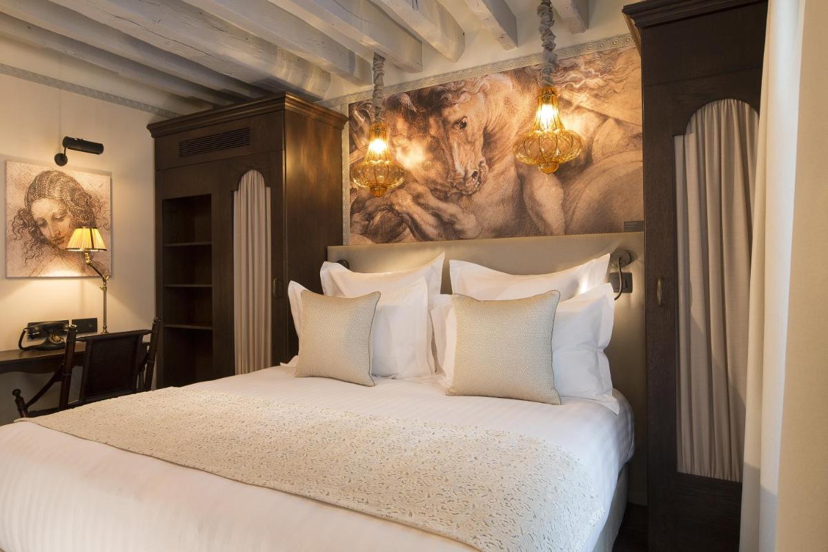 Un ou plusieurs lits dans un hébergement de l'établissement Hôtel Da Vinci & Spa