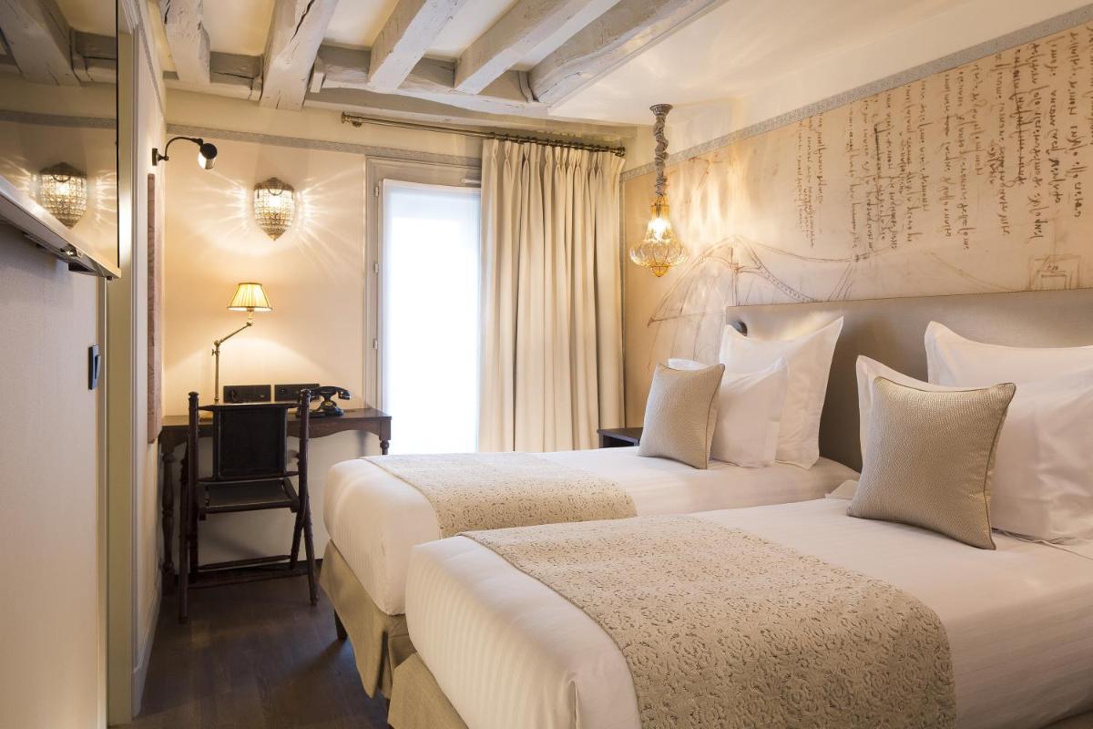 Un ou plusieurs lits dans un hébergement de l'établissement Hôtel Da Vinci & Spa