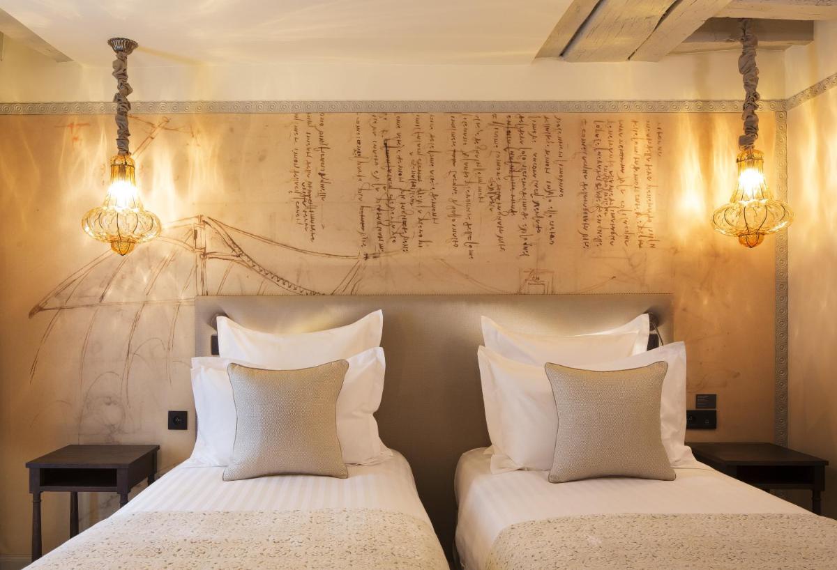 Un ou plusieurs lits dans un hébergement de l'établissement Hôtel Da Vinci & Spa
