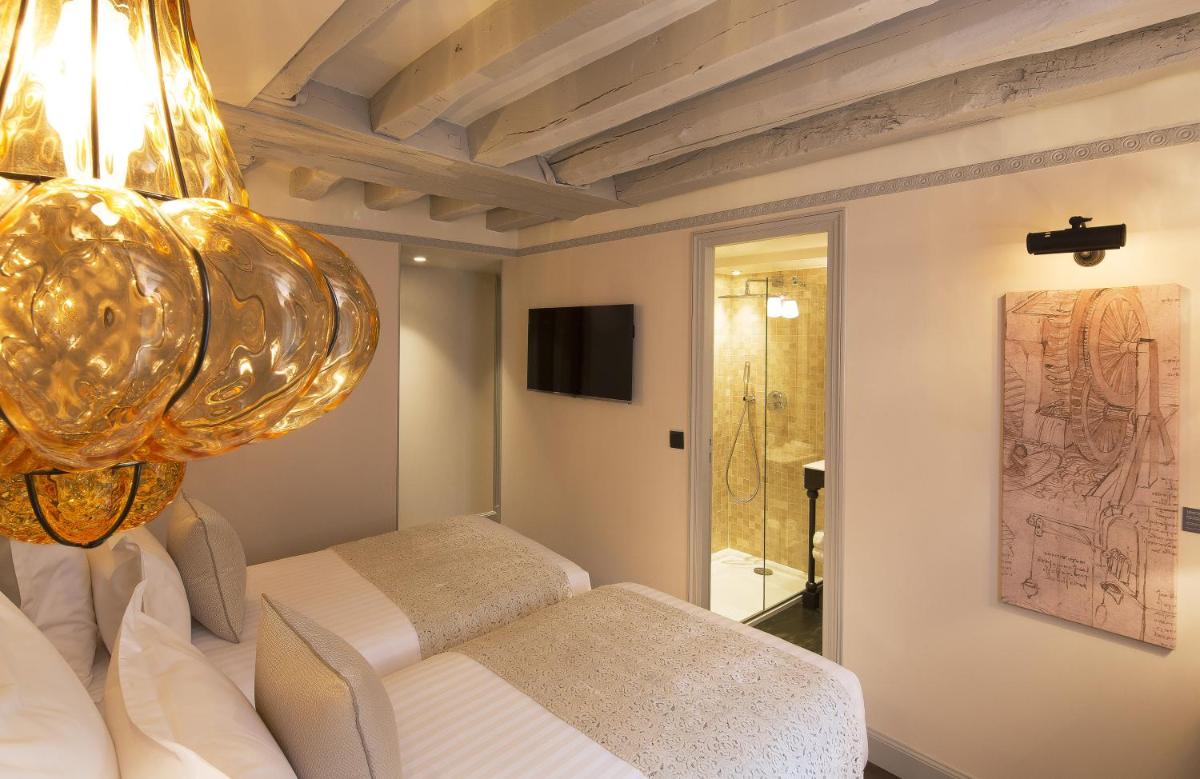 Un ou plusieurs lits dans un hébergement de l'établissement Hôtel Da Vinci & Spa