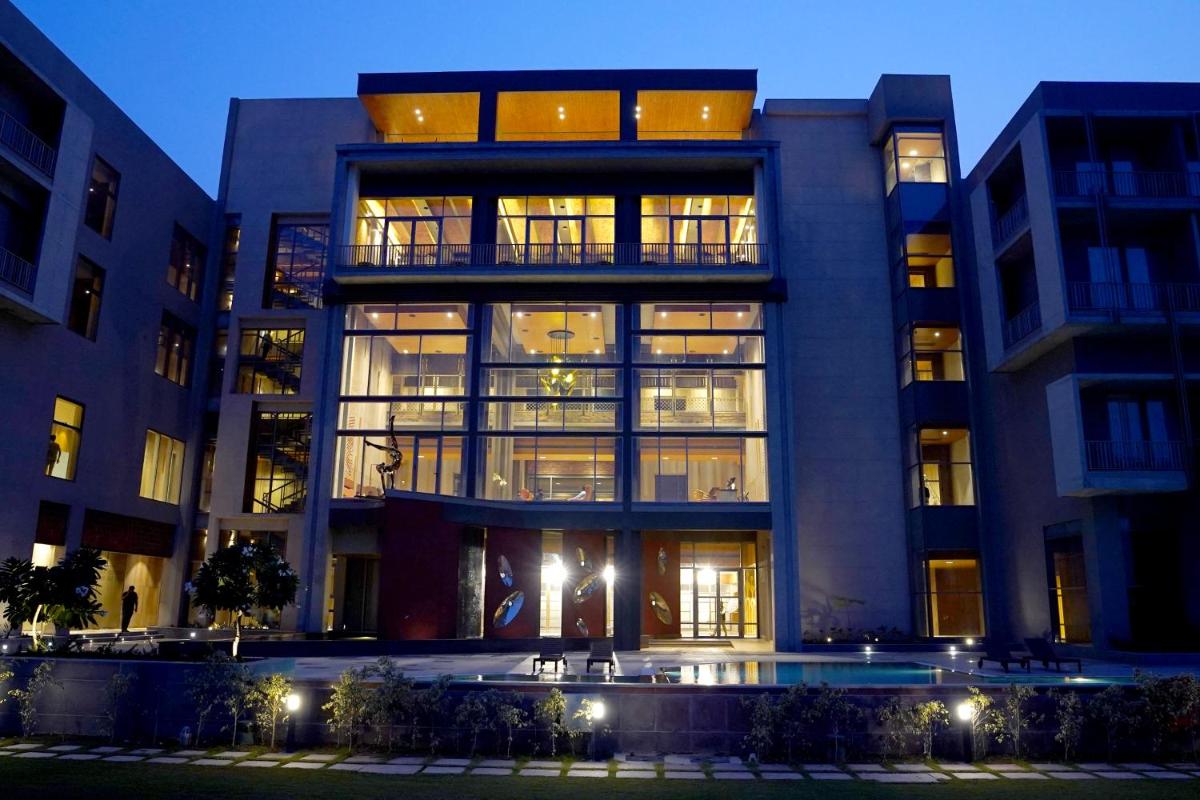 a large building with a pool in front of it at The Centrum in Lucknow