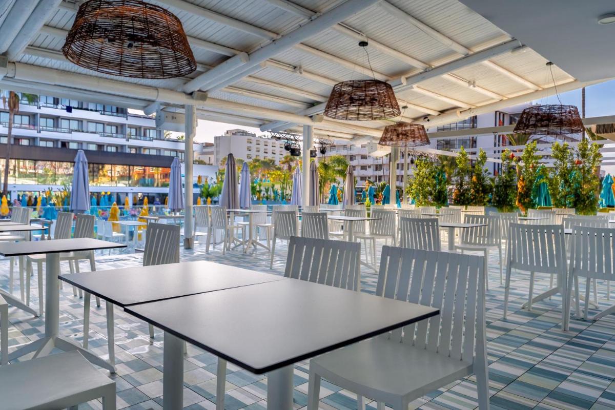 un patio con mesas y sillas en un crucero en Spring Hotel Bitácora, en Playa de las Américas