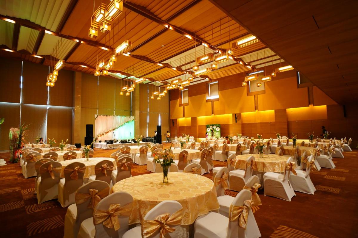 a large banquet hall with tables and chairs in it at The Centrum in Lucknow