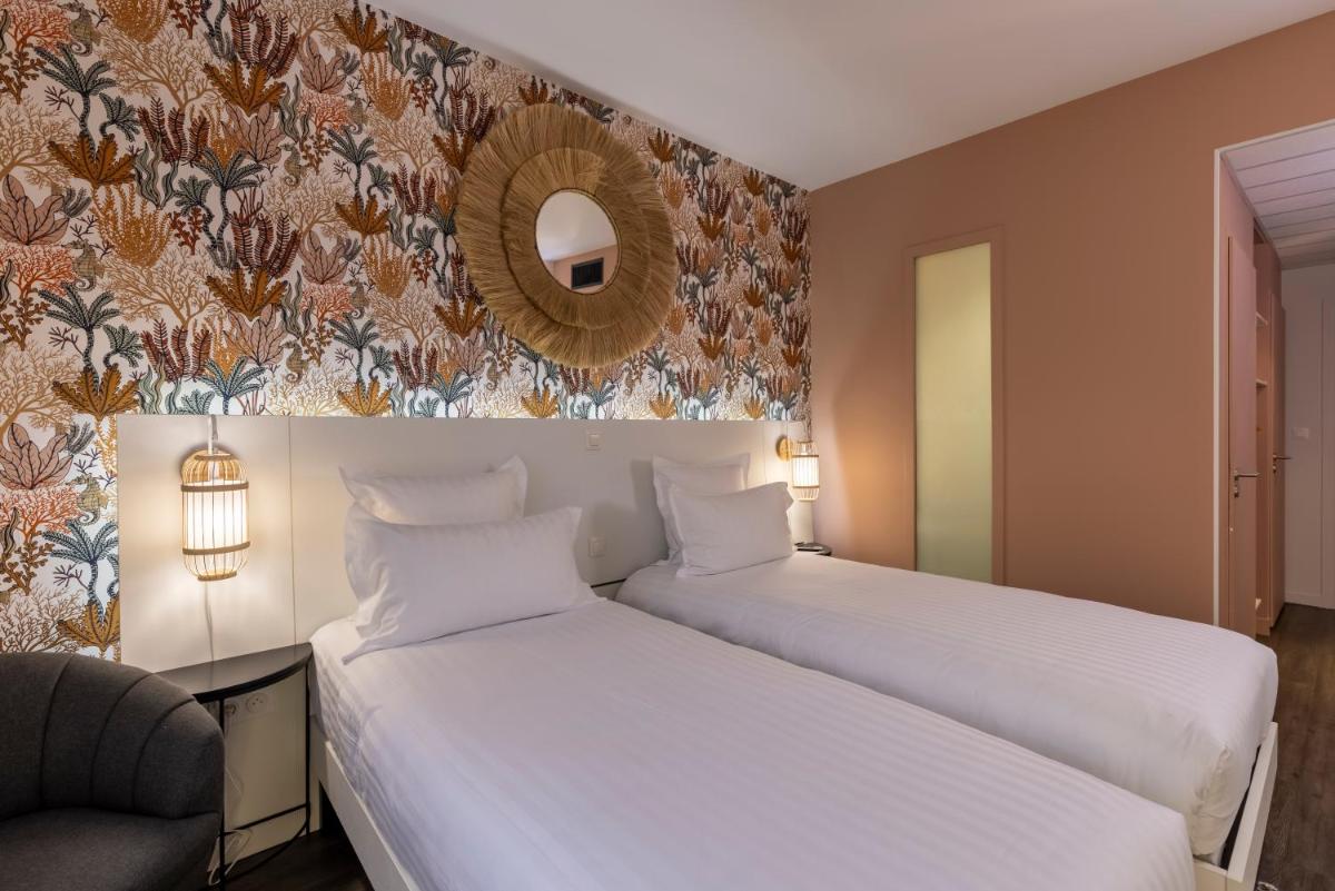 Un ou plusieurs lits dans un hébergement de l'établissement PADJA Hôtel & Spa Vannes