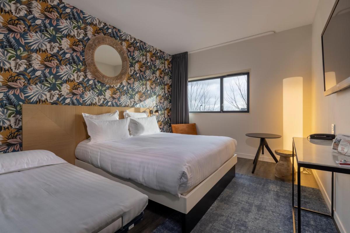 Un ou plusieurs lits dans un hébergement de l'établissement PADJA Hôtel & Spa Vannes