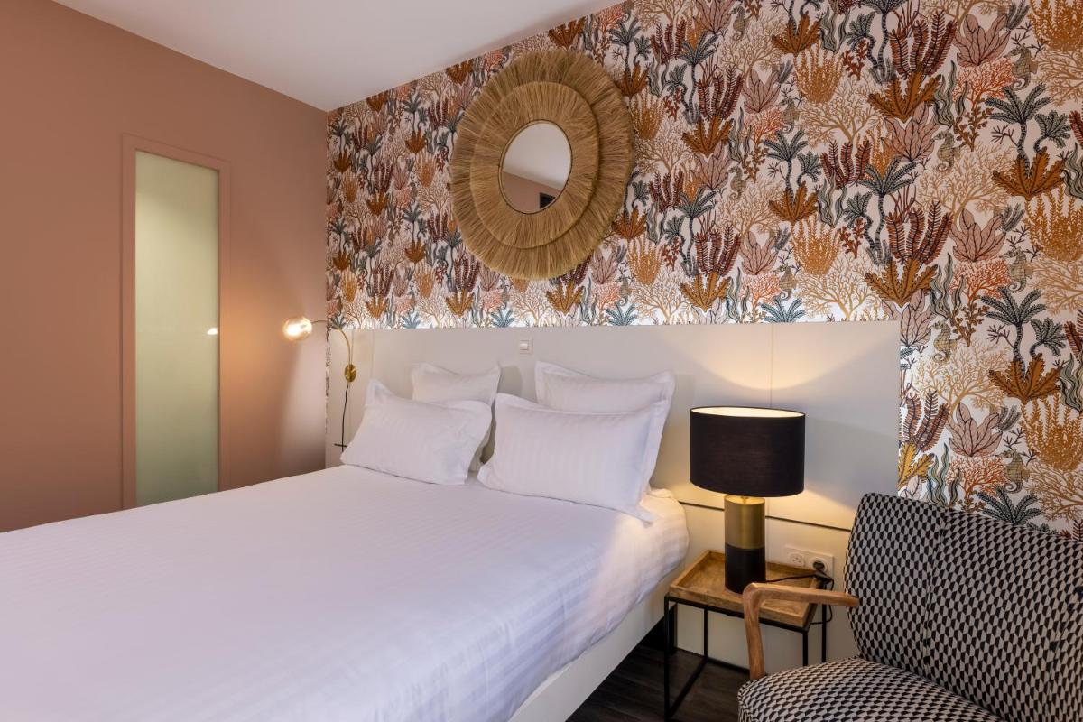 Un ou plusieurs lits dans un hébergement de l'établissement PADJA Hôtel & Spa Vannes