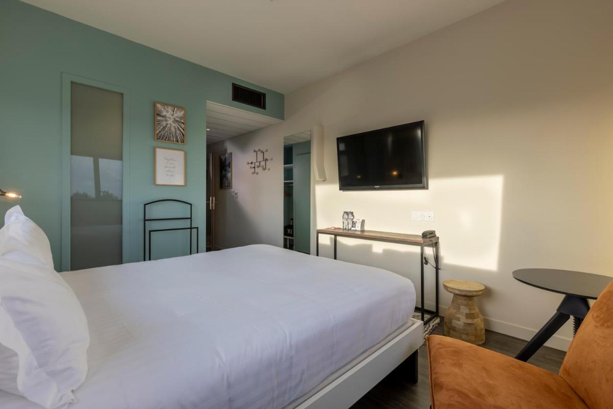 Un ou plusieurs lits dans un hébergement de l'établissement PADJA Hôtel & Spa Vannes