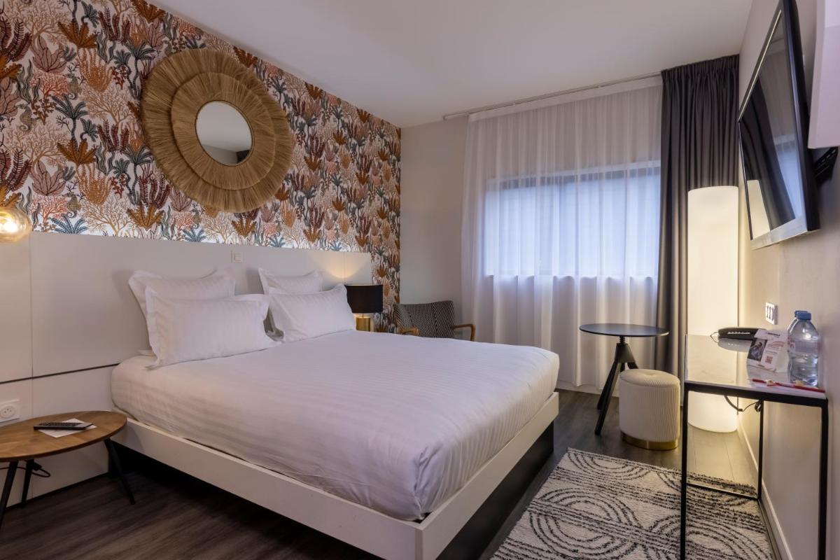 Un ou plusieurs lits dans un hébergement de l'établissement PADJA Hôtel & Spa Vannes