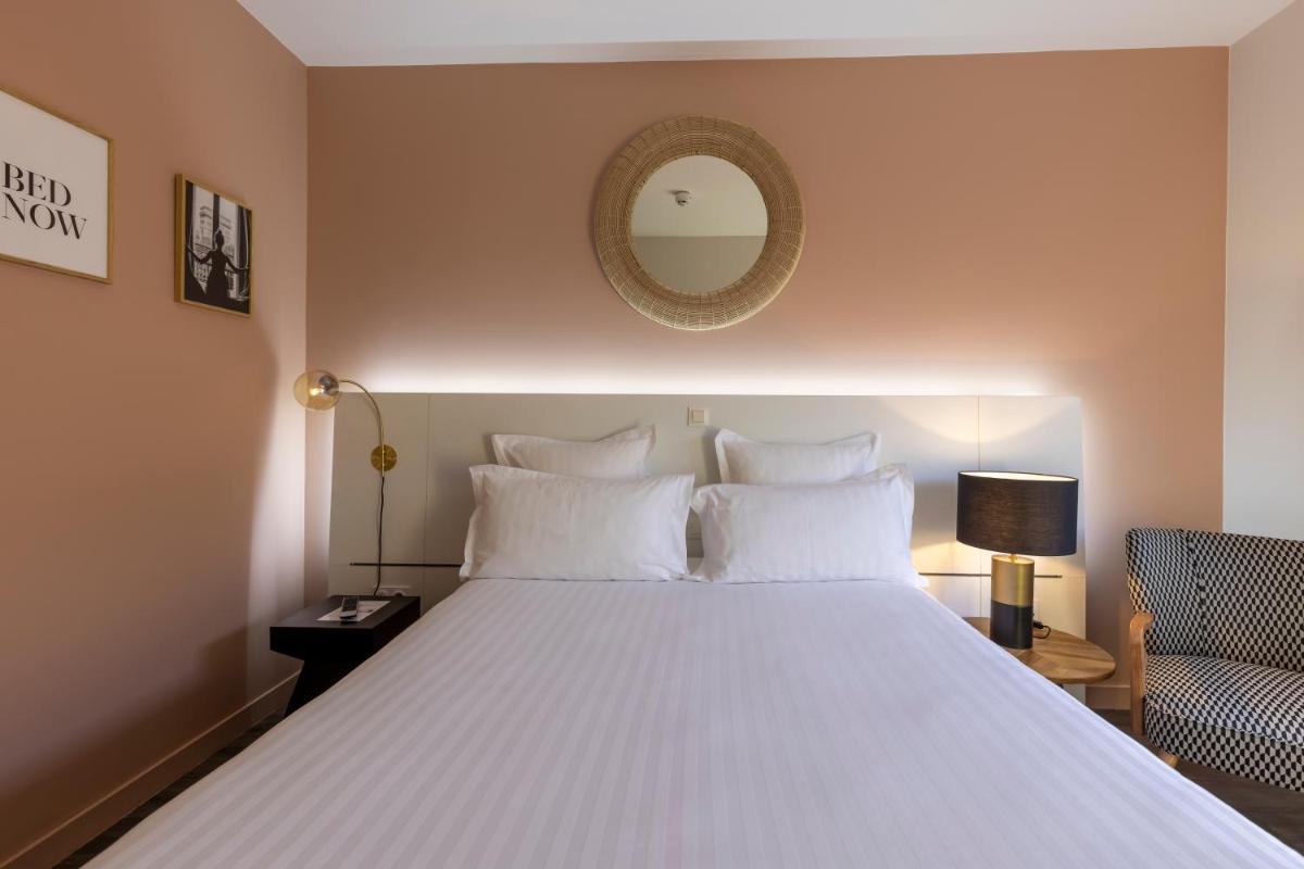 Un ou plusieurs lits dans un hébergement de l'établissement PADJA Hôtel & Spa Vannes
