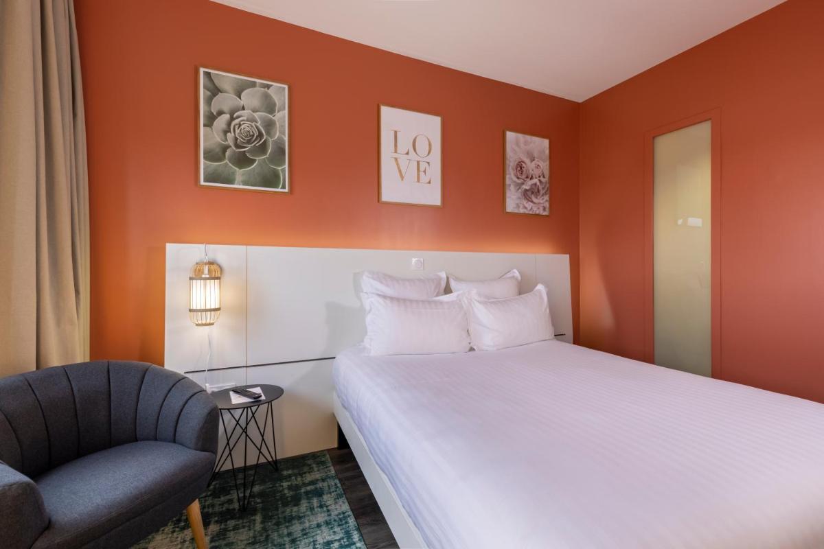 Un ou plusieurs lits dans un hébergement de l'établissement PADJA Hôtel & Spa Vannes