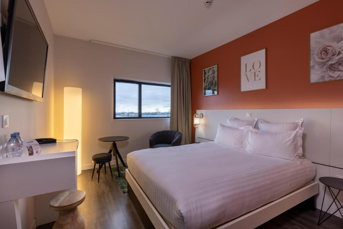 Un ou plusieurs lits dans un hébergement de l'établissement PADJA Hôtel & Spa Vannes