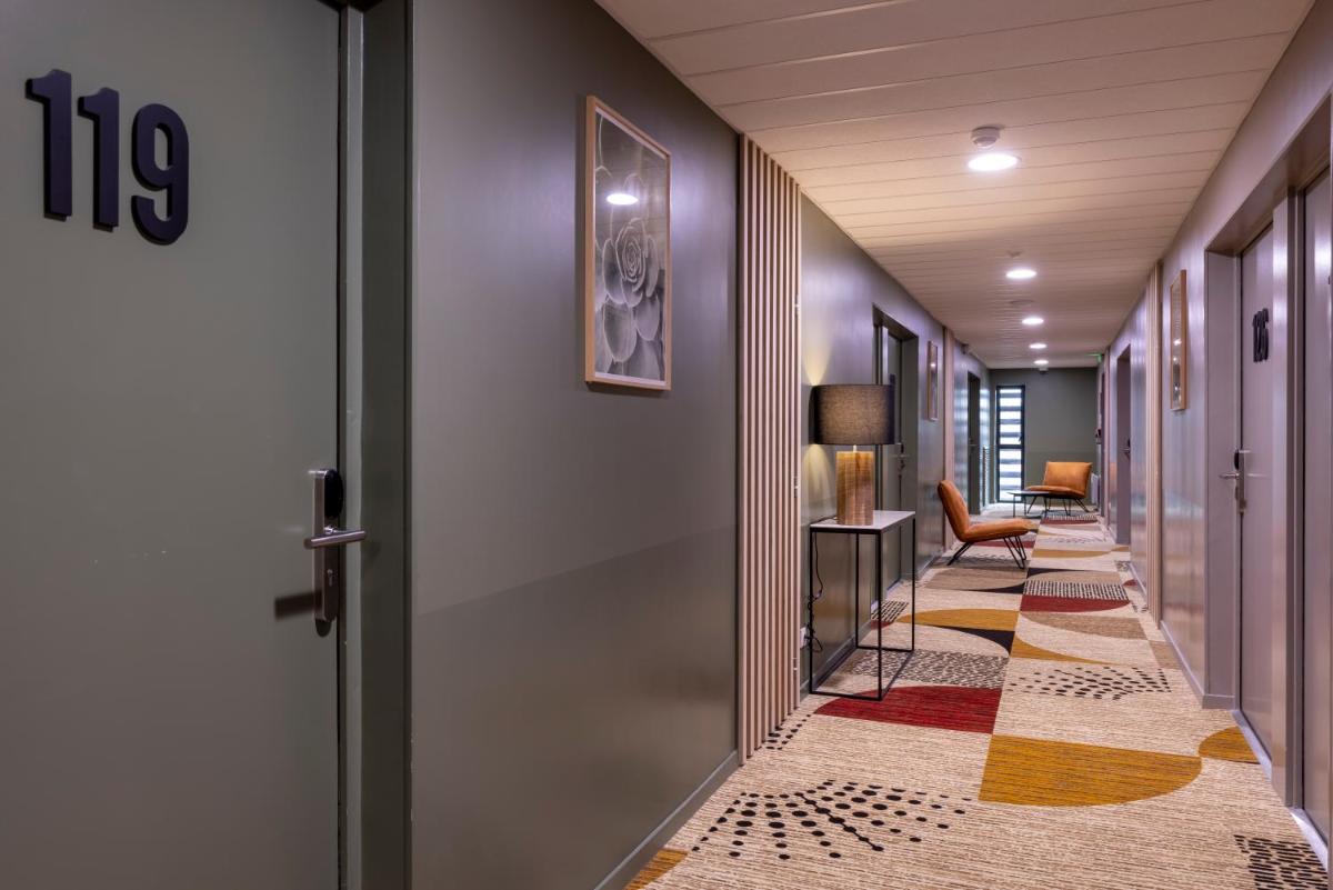 Un ou plusieurs lits dans un hébergement de l'établissement PADJA Hôtel & Spa Vannes