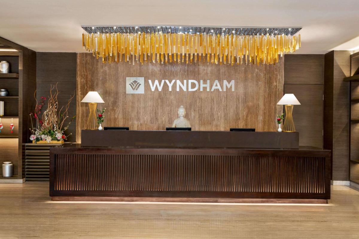 a lobby of a hotel with a reception desk at Wyndham Ahmedabad Shela in Ahmedabad