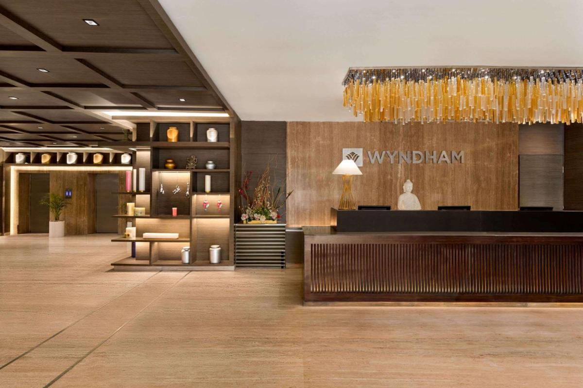 a lobby of a hotel with a reception desk at Wyndham Ahmedabad Shela in Ahmedabad