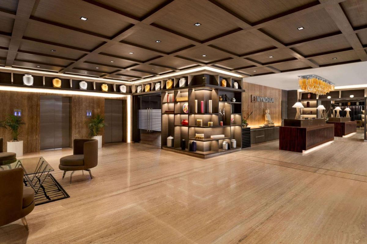 a lobby of a hotel with a wine cellar at Wyndham Ahmedabad Shela in Ahmedabad